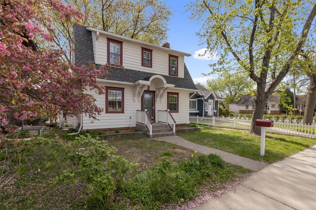 dutch colonial with a chimney and roof with shingles