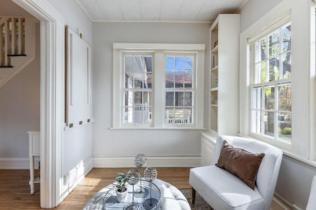 sitting room featuring light wood-type flooring and baseboards
