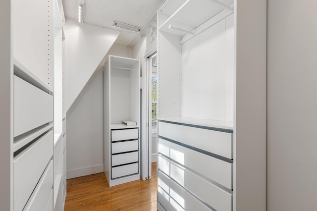 spacious closet with light wood-style floors