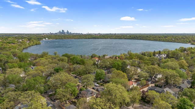 aerial view of property's location with a large body of water and a heavily wooded area