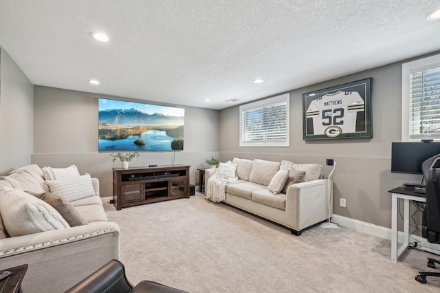 carpeted living area featuring a textured ceiling, recessed lighting, healthy amount of natural light, and baseboards