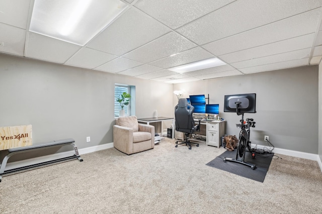 carpeted office with a paneled ceiling and baseboards