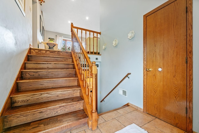 stairway with tile patterned floors