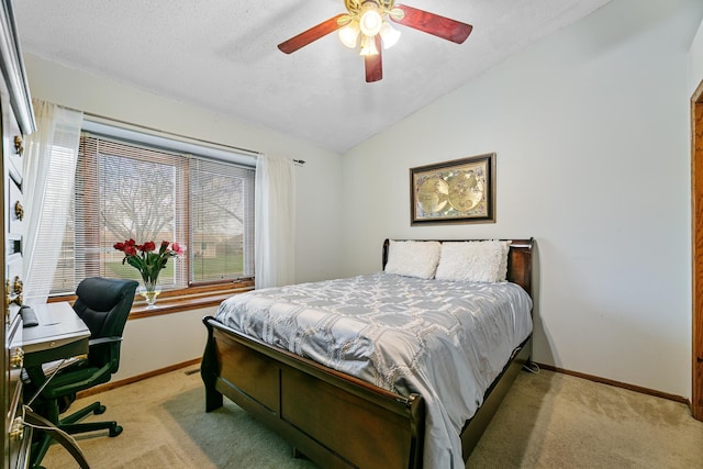 bedroom with baseboards, light carpet, vaulted ceiling, and ceiling fan