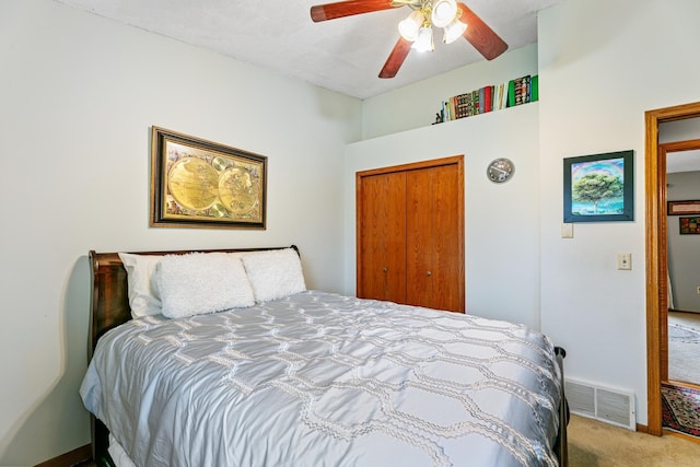bedroom with carpet floors, ceiling fan, and a closet