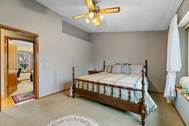 bedroom with carpet, baseboards, and a ceiling fan