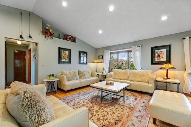 living area with lofted ceiling, light wood-type flooring, and recessed lighting