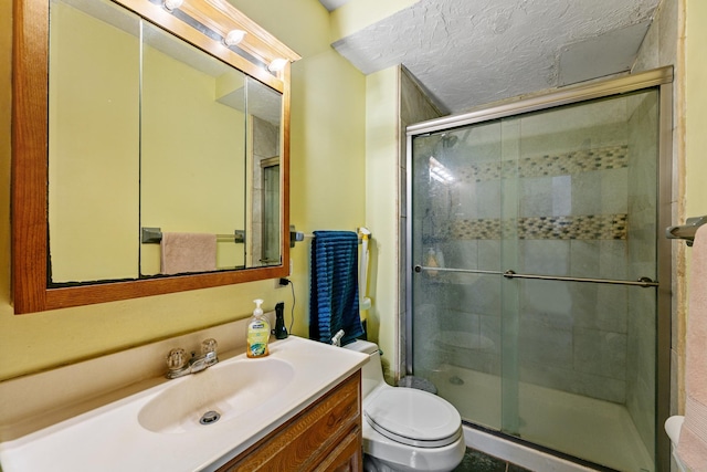 full bath featuring a stall shower, toilet, and vanity