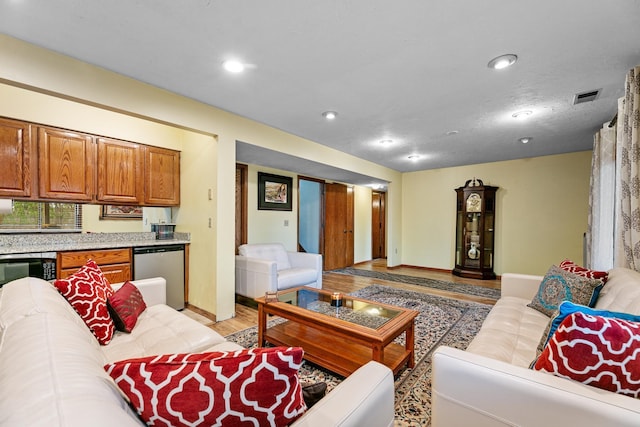 living area featuring light wood finished floors, baseboards, and recessed lighting