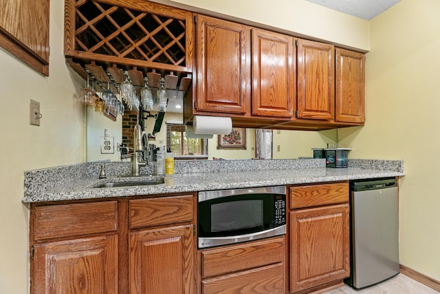 indoor wet bar featuring stainless steel microwave, fridge, and baseboards