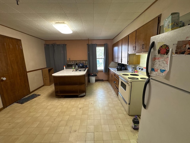 2526 Garnet Ave, Slayton, MN 56172 - kitchen featuring a sink, light floors, white appliances, and light countertops
