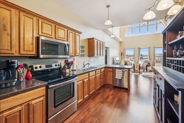 317 Main St W Unit 301, Ashland, WI 54806 - kitchen featuring appliances with stainless steel finishes, a sink, dark countertops, and brown cabinets