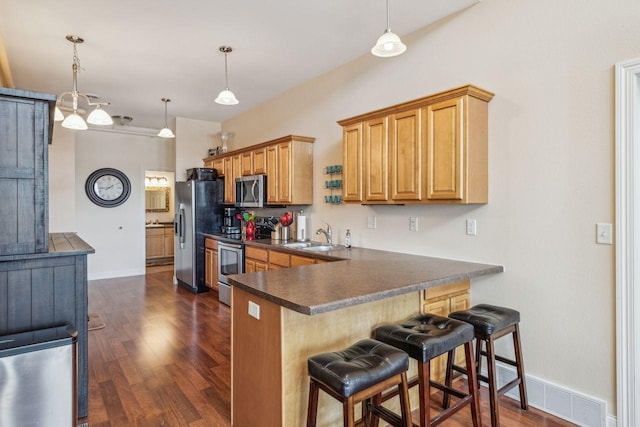 317 Main St W Unit 301, Ashland, WI 54806 - kitchen with appliances with stainless steel finishes, dark countertops, dark wood finished floors, and baseboards