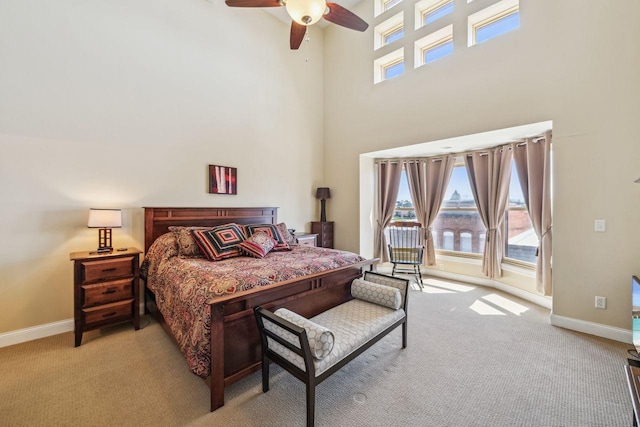 317 Main St W Unit 301, Ashland, WI 54806 - bedroom with light carpet, a towering ceiling, baseboards, ceiling fan, and access to outside
