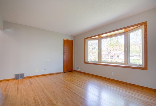 unfurnished room featuring light wood-type flooring and baseboards