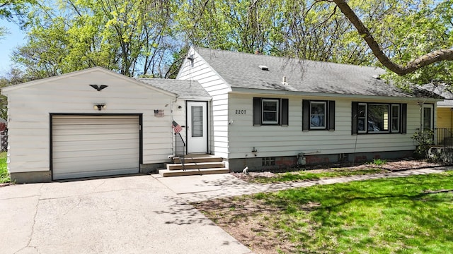 ranch-style home with roof with shingles, concrete driveway, a garage, entry steps, and a front yard