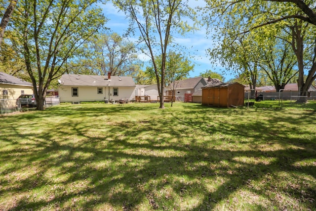 view of yard with a storage shed and an outbuilding