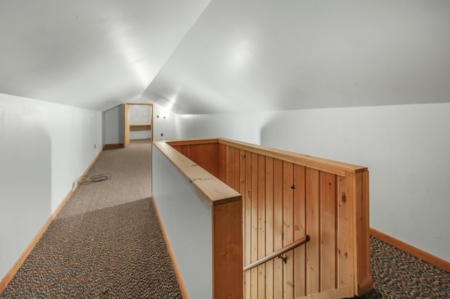 additional living space featuring carpet flooring, lofted ceiling, and baseboards