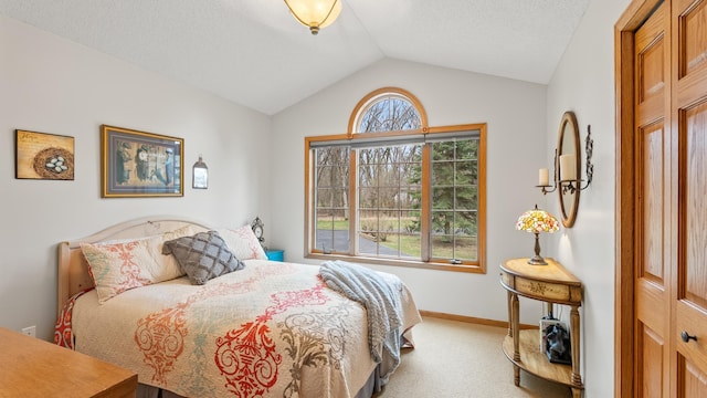 carpeted bedroom featuring vaulted ceiling and baseboards