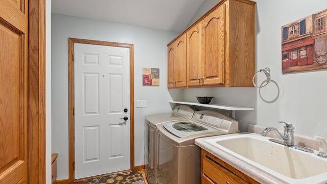 clothes washing area with cabinet space, washer and dryer, and baseboards