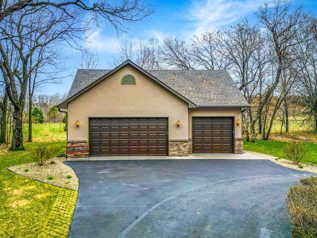 garage featuring asphalt driveway