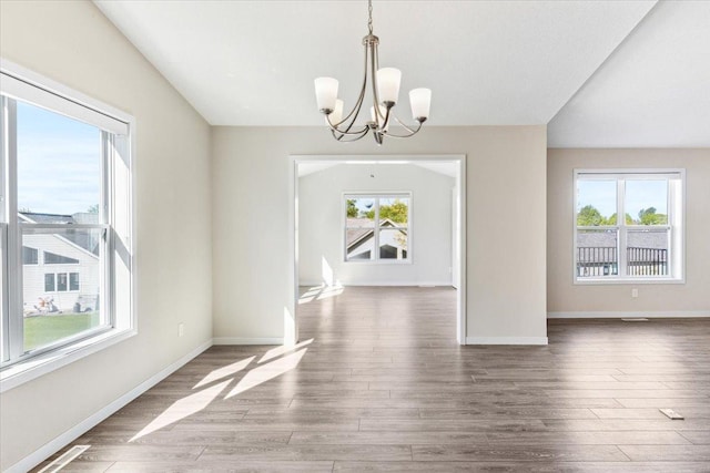983 Aurora Cir, Red Wing, MN 55066 - unfurnished dining area with a chandelier, wood finished floors, and baseboards