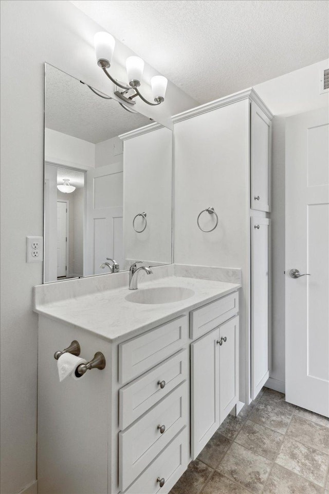 983 Aurora Cir, Red Wing, MN 55066 - bathroom with a textured ceiling and vanity