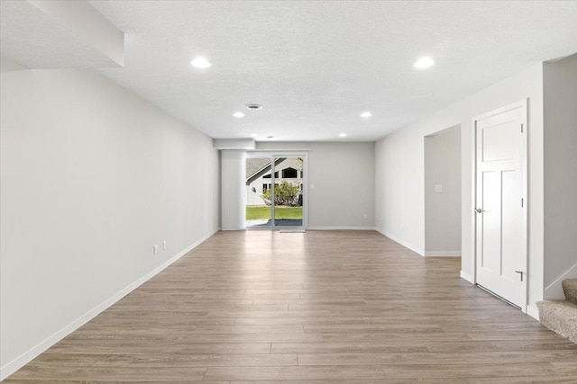 983 Aurora Cir, Red Wing, MN 55066 - empty room featuring wood finished floors, stairs, recessed lighting, a textured ceiling, and baseboards