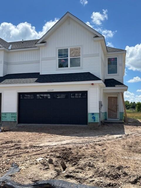 6259 205th St N, Forest Lake, MN 55025 - view of front of home with board and batten siding, an attached garage, and roof with shingles