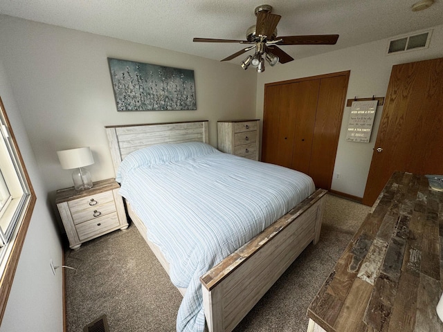 bedroom featuring a closet, wood finished floors, ceiling fan, and a textured ceiling
