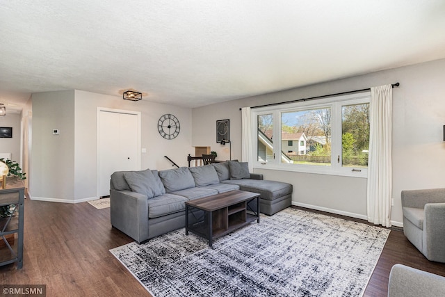 living room with dark wood-style flooring and baseboards