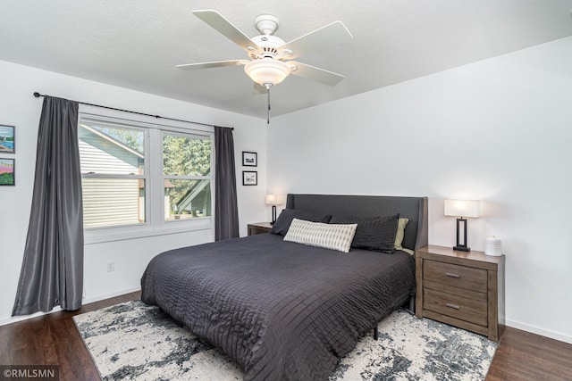 bedroom with wood finished floors, baseboards, and ceiling fan