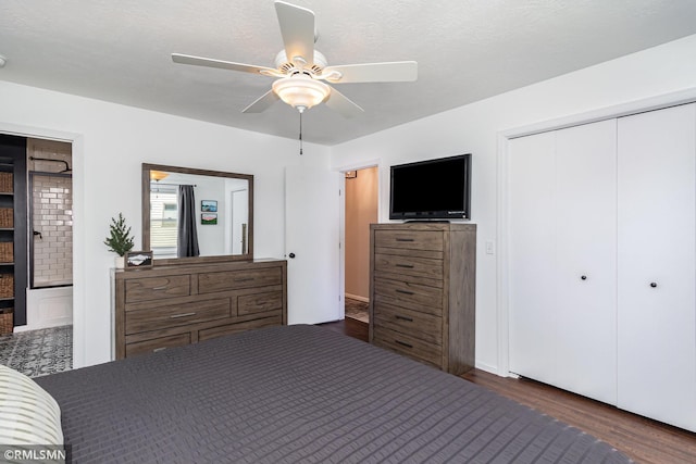 bedroom featuring wood finished floors, a closet, ensuite bath, and ceiling fan