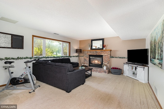 living area with a textured ceiling, carpet floors, and a fireplace