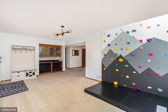 game room with carpet flooring, a chandelier, and baseboards