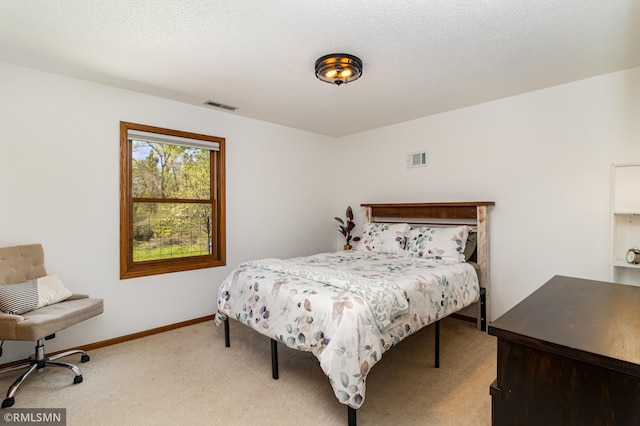 bedroom with light carpet and baseboards