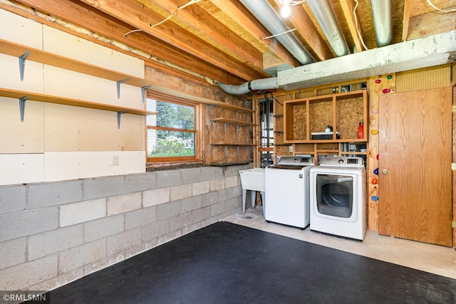 below grade area with washer and dryer and concrete block wall