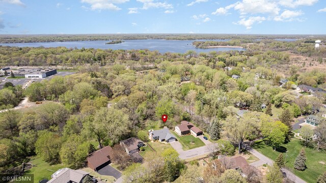 view of property location with a large body of water and a forest