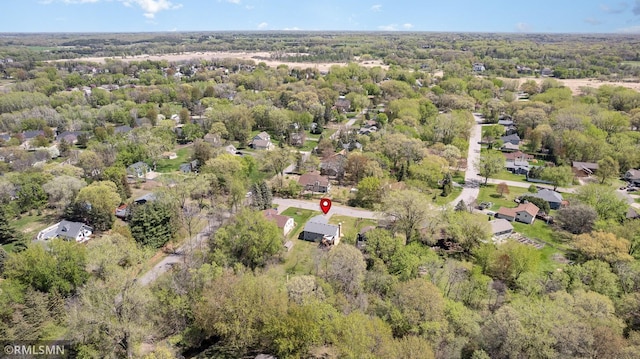 aerial view of property and surrounding area featuring a forest