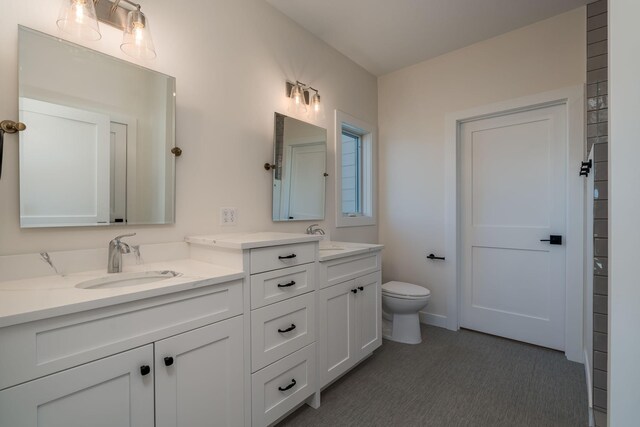 full bath featuring a sink, double vanity, and toilet