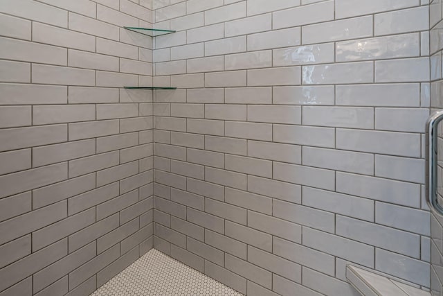 bathroom with a tile shower
