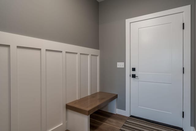 mudroom featuring dark wood-style flooring and baseboards