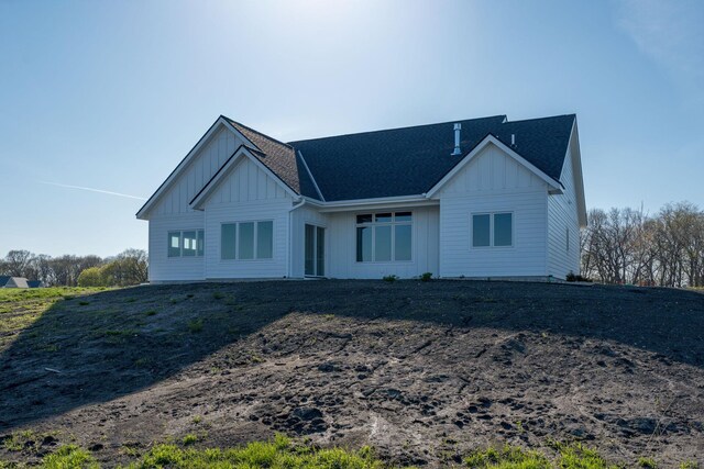 view of front of home with board and batten siding and a shingled roof
