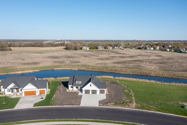 aerial view of property and surrounding area featuring a nearby body of water