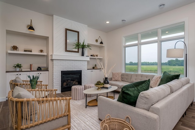 2132 Deerwood Dr, North Mankato, MN 56003 - living room with wood finished floors, built in features, a brick fireplace, and recessed lighting