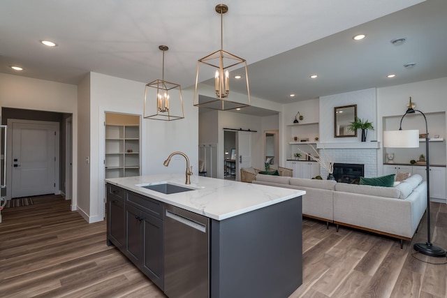 2132 Deerwood Dr, North Mankato, MN 56003 - kitchen featuring dishwasher, built in shelves, wood finished floors, a barn door, and recessed lighting
