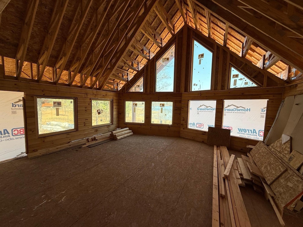 unfurnished sunroom featuring vaulted ceiling