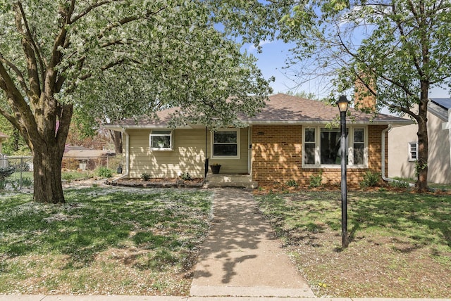 ranch-style house featuring brick siding