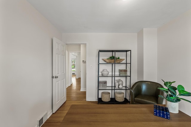living area with wood finished floors and baseboards