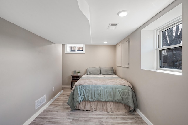 bedroom featuring baseboards and light wood-style floors